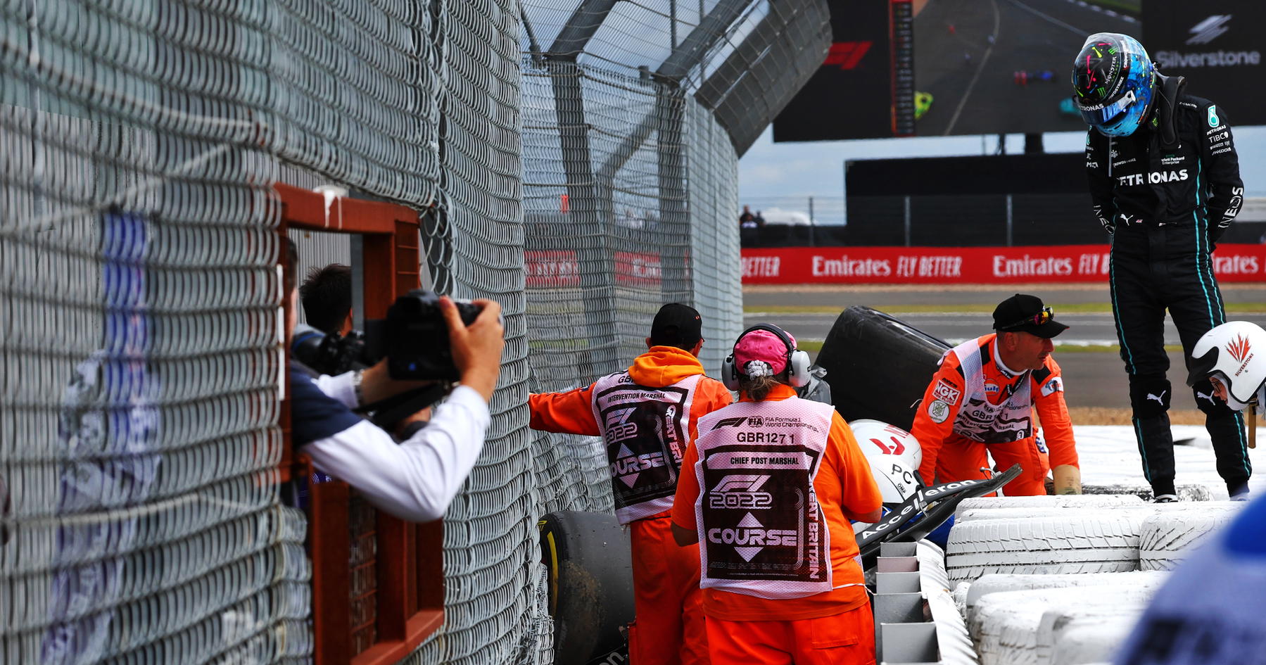 George Russell Shares Life-Threatening Choice After Shocking F1 Crash 3 Zhou Guanyu’s Alfa Romeo at rest against the catch fencing after the start crash