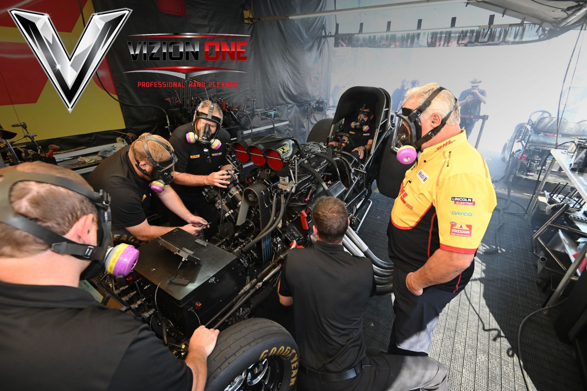NHRA and VizionOne Honor Nitro Crew’s Hardest Worker with Grunt of the Race Award 2 NHRA nitro crew members service a Top Fuel car between rounds