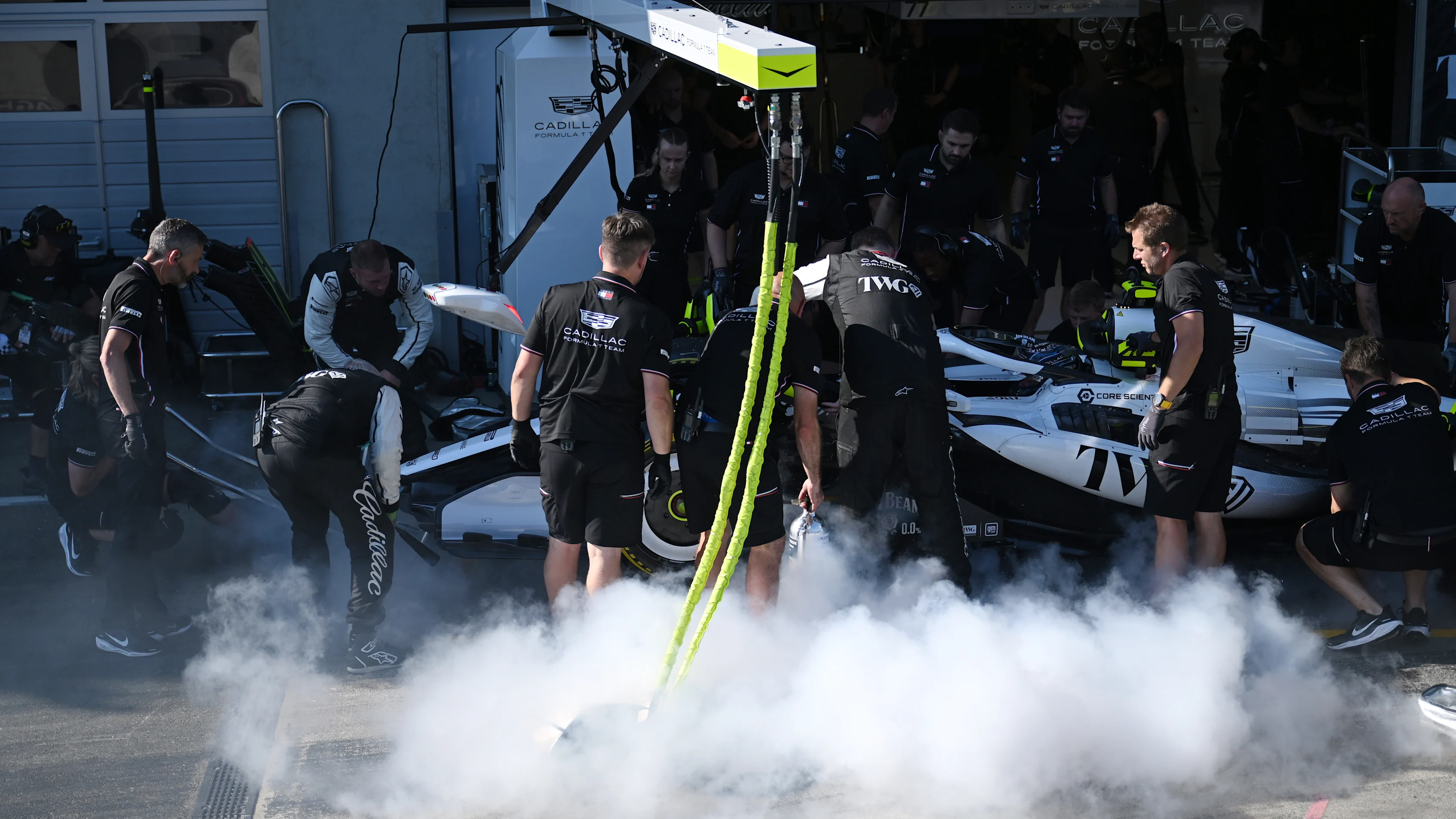 Cadillac Faces Crushing Setback with Early Car Fires at Austrian GP 3 Cadillac mechanics assess the car after brake issues in Austria