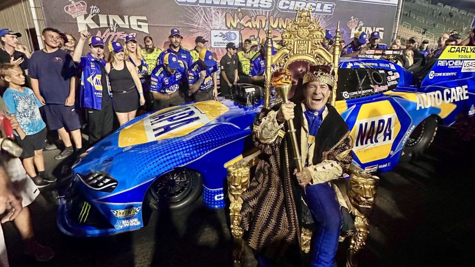 Ron Capps Triumphs as ‘King of Nitro’ in All-Ron Capps Motorsports Night Under Fire Finale 3 Ron Capps Motorsports teammates Maddi Gordon and Ron Capps prepare for the Night Under Fire final