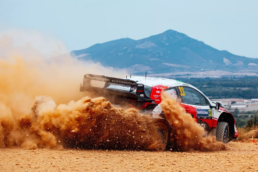 Elfyn Evans Hit by Puncture Before Power Stage WRC Title Clash 2 Elfyn Evans changes a front-right wheel after a puncture during Rally Italy Sardinia, stage 16.