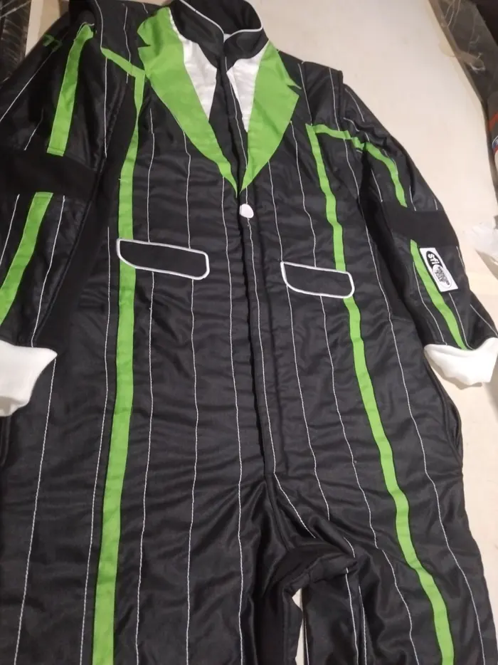 Black pinstripe suit with green trim laid flat Black pinstripe suit with green trim laid flat