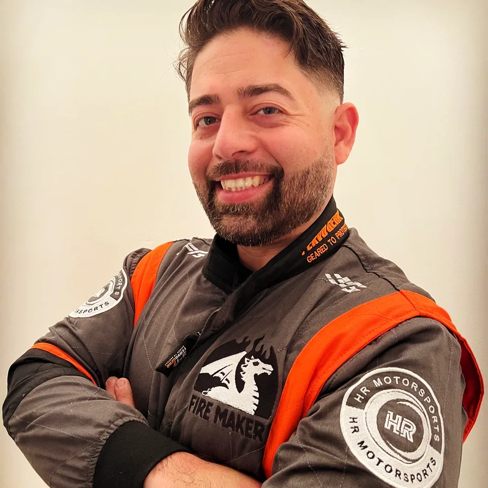 David Post smiling in his grey and orange FervoGear suit with sponsor logos on the chest and sleeves David Post smiling in his grey and orange FervoGear suit with sponsor logos on the chest and sleeves