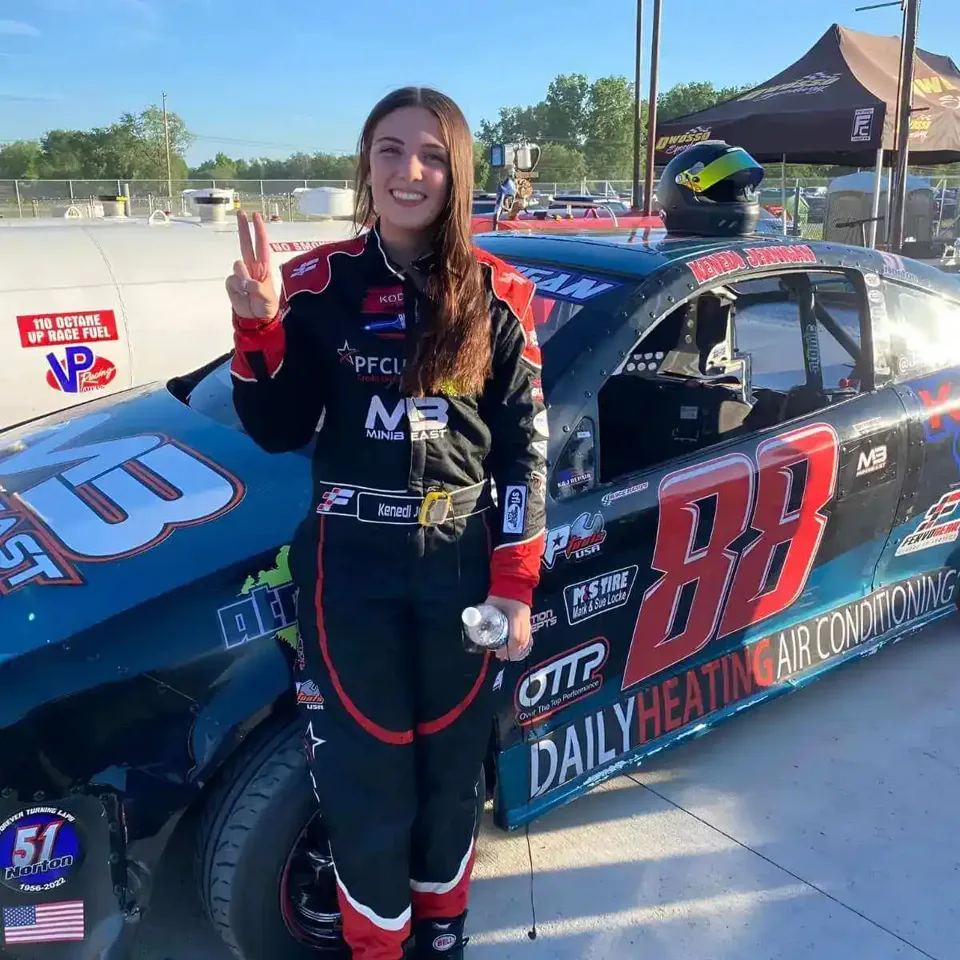 Kenedi Jernigan in her custom black FervoGear fire suit beside her number 88 race car Kenedi Jernigan in her custom black FervoGear fire suit beside her number 88 race car