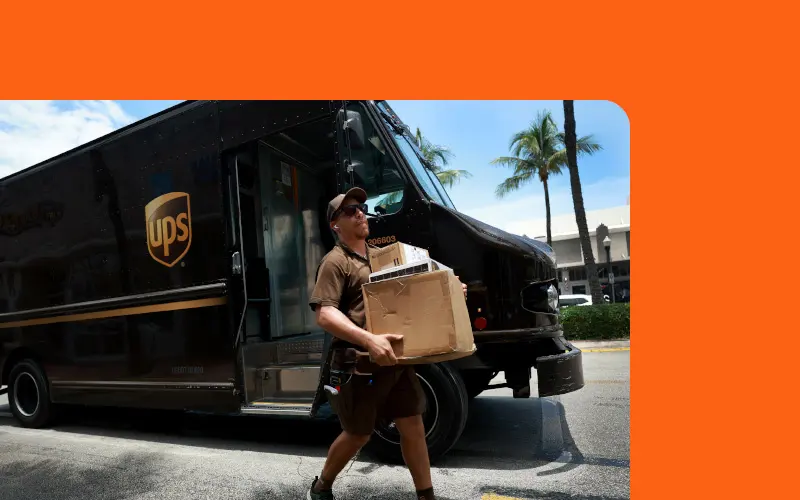 A UPS driver delivering a package A UPS driver delivering a package